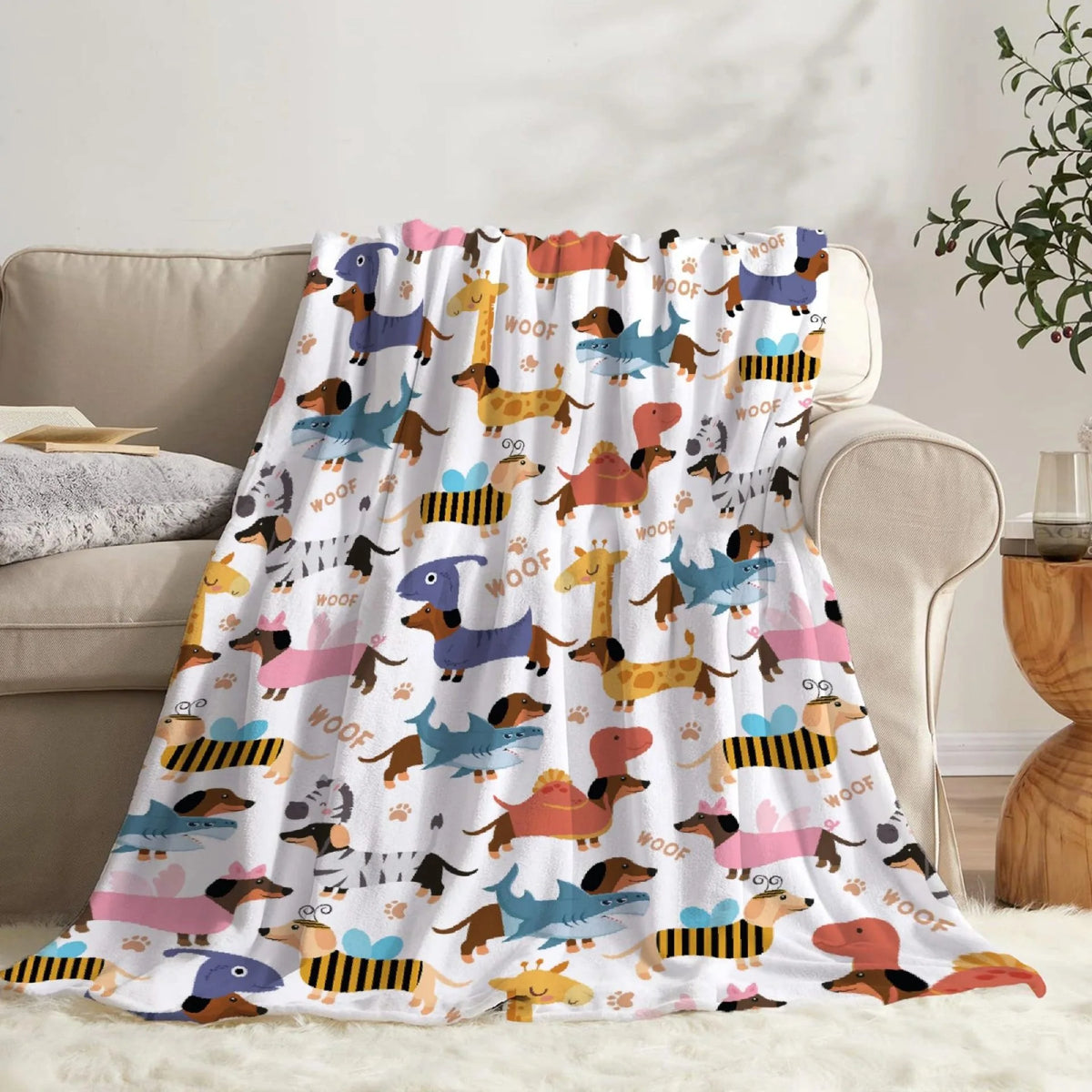 A colorful fabric blanket featuring various cartoon dog illustrations in shades of brown, yellow, pink, and blue.