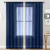 Navy blue sheer curtain with a rod pocket hanging over a white window frame.
