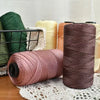 Spools of pink and brown ice silk crochet yarn for crafting thread