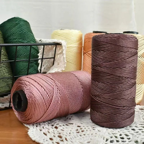 Spools of pink and brown ice silk crochet yarn for crafting thread