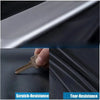 Close-up of a metal key demonstrating scratch and tear resistance on a dark fabric surface.