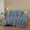 A gray botanical print duvet cover set featuring white foliage and branches on a bed.