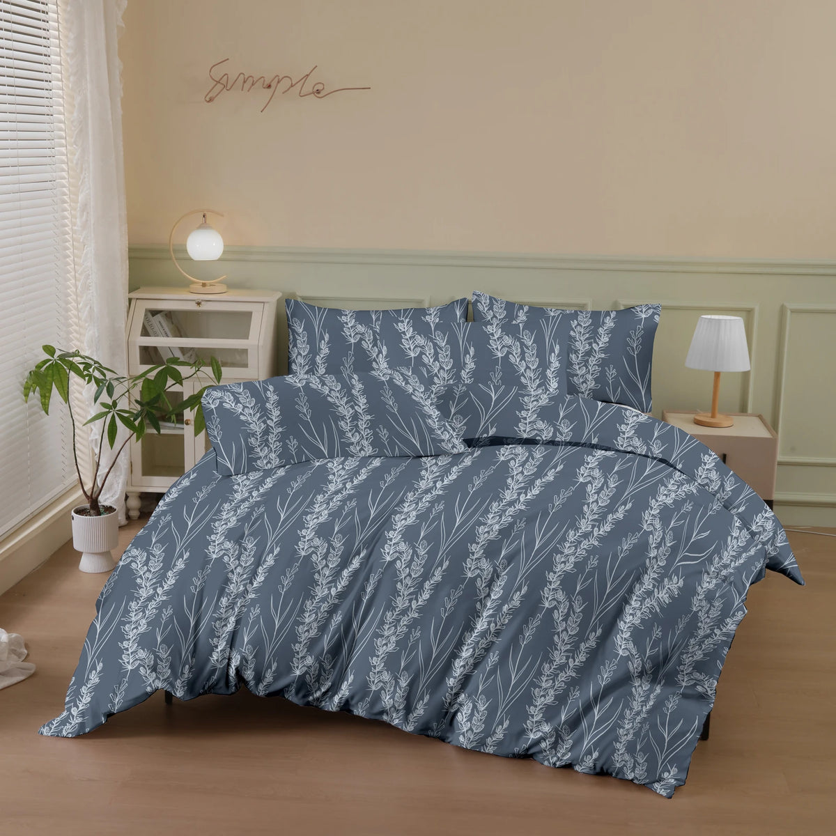 A gray botanical print duvet cover set featuring white foliage and branches on a bed.