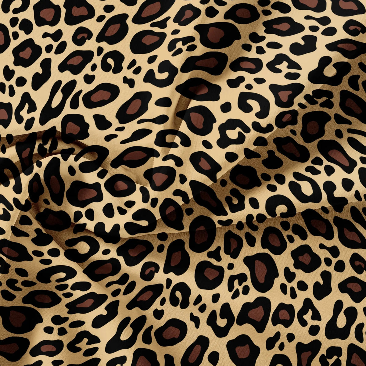 A close-up of a luxury leopard print fabric in shades of brown and beige, draped and folded.