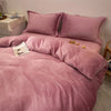 A luxurious pink flannel duvet cover set with matching pillows on a bed.
