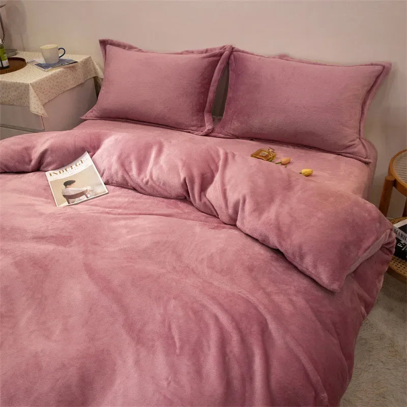 A luxurious pink flannel duvet cover set with matching pillows on a bed.