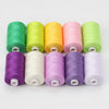 A row of twelve spools of brightly colored polyester thread in various shades including green, yellow, pink, and purple.