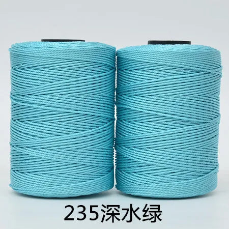 Two spools of teal blue hand knitting and crochet cord for crafting