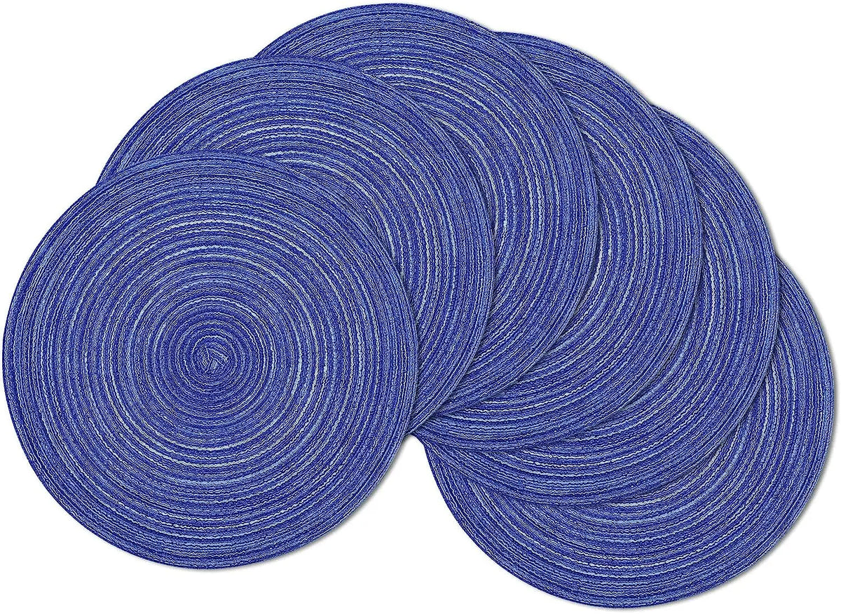 A set of six round blue braided placemats stacked and laid out.