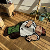 A funny cartoon rug depicting a person with a white shirt and green pants lying on a wooden floor.