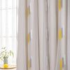 Elegant wheat field embroidered white and gray sheer curtain hanging by a window