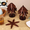 A set of natural wooden coasters featuring leaf-shaped designs displayed on a light wooden surface.