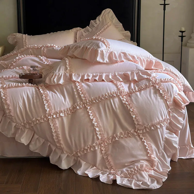 A pink ruffled duvet cover set with delicate lace trim is displayed on a bed.