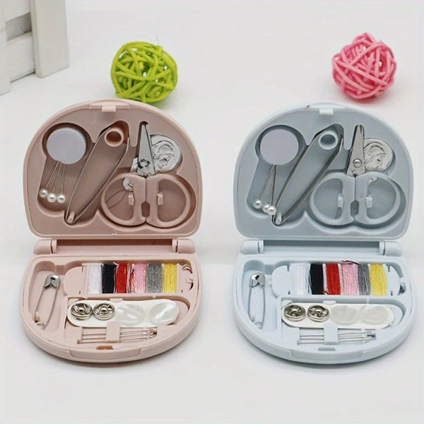 A portable mini sewing kit with pink and gray components, including needles, scissors, and thread spools.