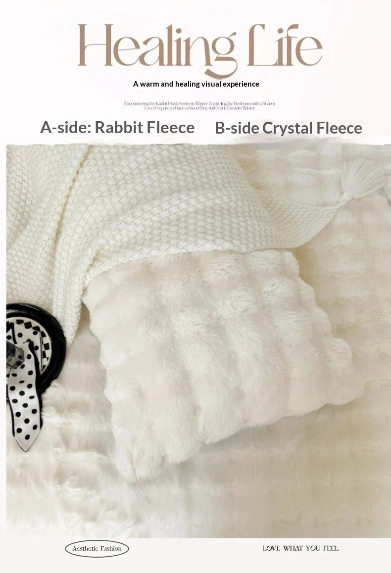 A close-up of a white rabbit fleece textile product showing its texture and softness.