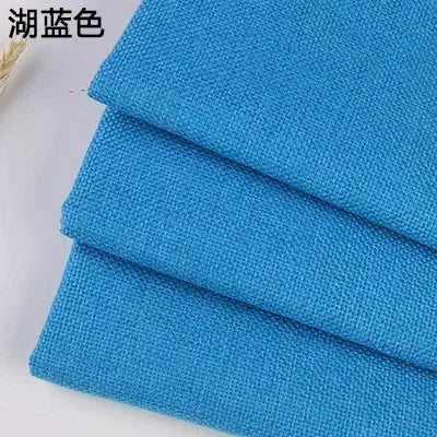 Blue coarse linen and cotton fabric stacked and folded for DIY projects