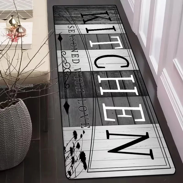 A long, rectangular floor mat with the text 'KITCHEN' vertically displayed in a rustic font on a dark background.