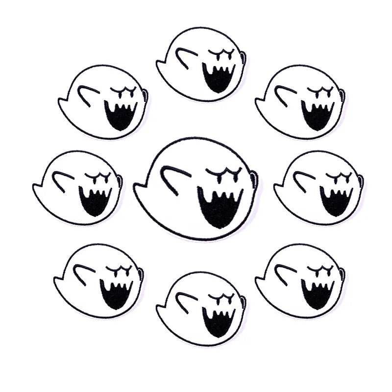 A set of seven black and white embroidered patches depicting screaming or angry faces.