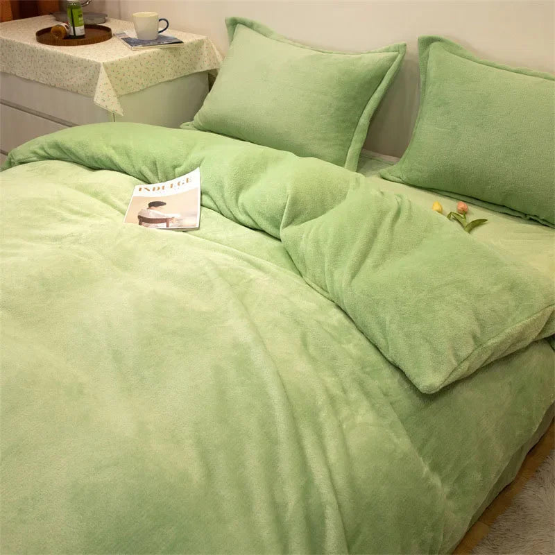 A luxurious sage green flannel duvet cover set with matching pillows on a bed.