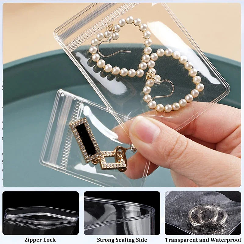Clear plastic jewelry storage bags showing a pearl necklace and a gold charm, demonstrating zipper lock, strong sealing side,