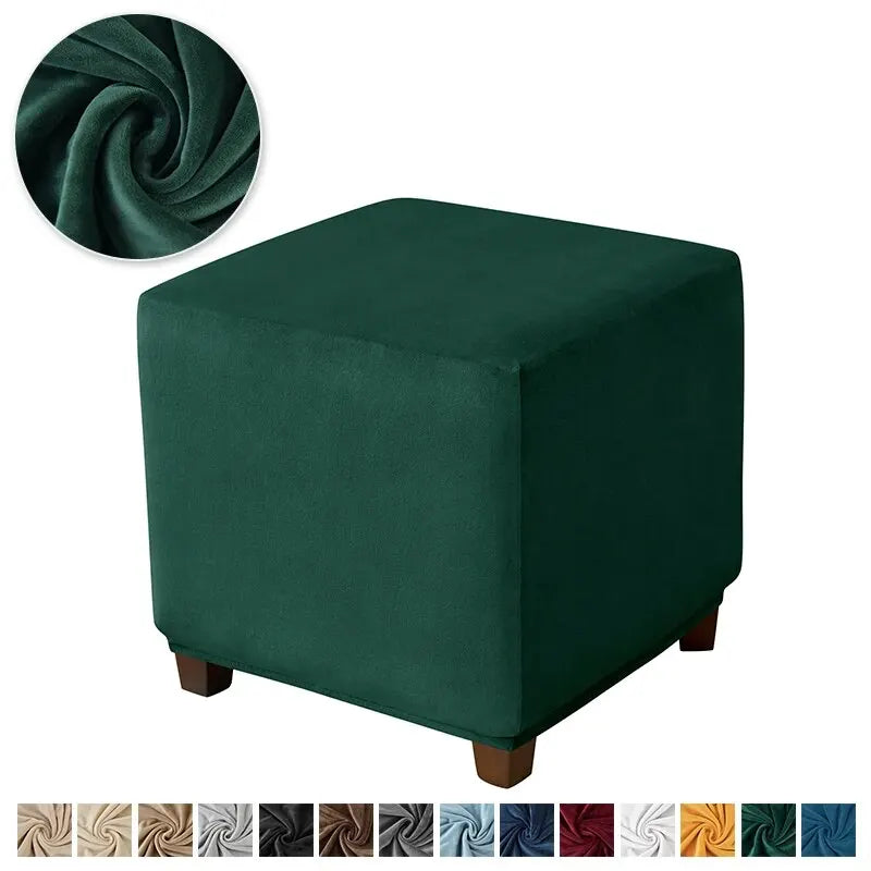 A dark emerald green velvet ottoman slipcover with a rolled fabric detail.