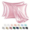 A set of pink satin pillowcases folded and displayed, with various shades including white, blush, and green.