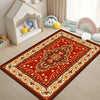 A vibrant red and orange Bohemian Persian area rug with intricate patterns on a light wood floor.