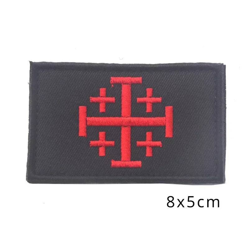 Black embroidered patch featuring a red Crusader and Knight symbol.