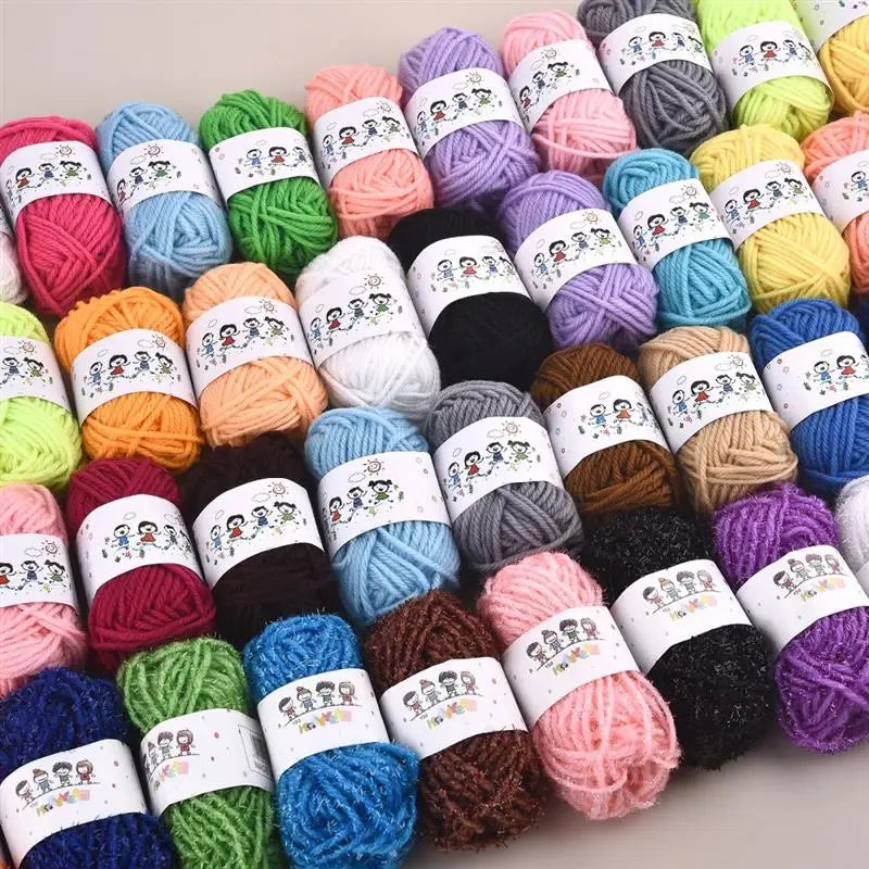 A collection of 12 colors of soft acrylic yarn balls arranged in a row.