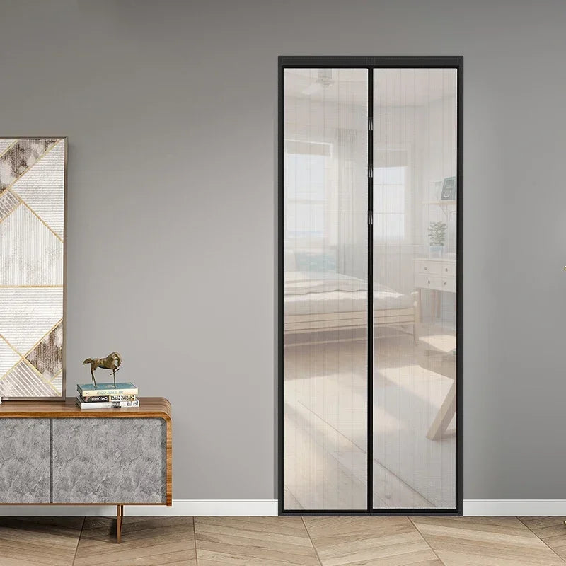 A modern, full-length glass sliding door with a black frame and sheer white mosquito net curtains.