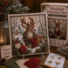 A framed fabric art kit featuring a deer in a snowy woodland scene with red berries and evergreen elements.
