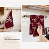 A close-up photo showing a maroon kitchen towel hanging on a rack, emphasizing its texture and design.