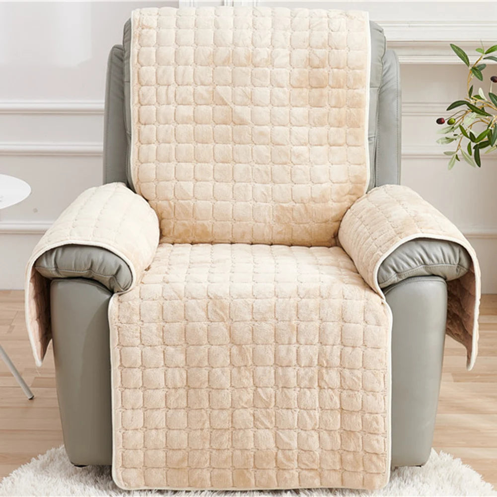A beige quilted stretch recliner cover with storage pockets shown on a chair.