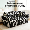 Black and white patterned sofa cover displayed on a light rug in a bright room.