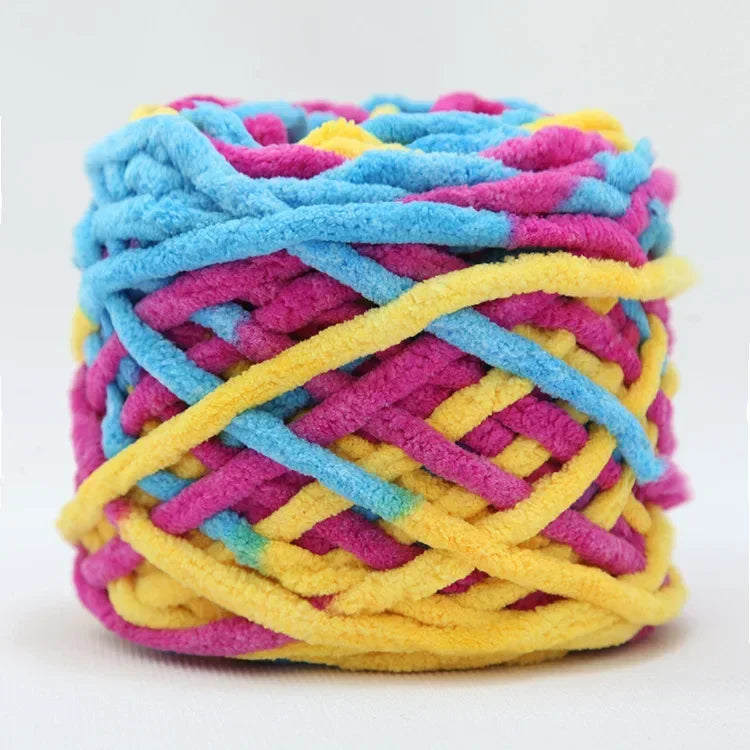 A ball of brightly colored chenille knitting yarn in shades of blue, pink, yellow, and purple.