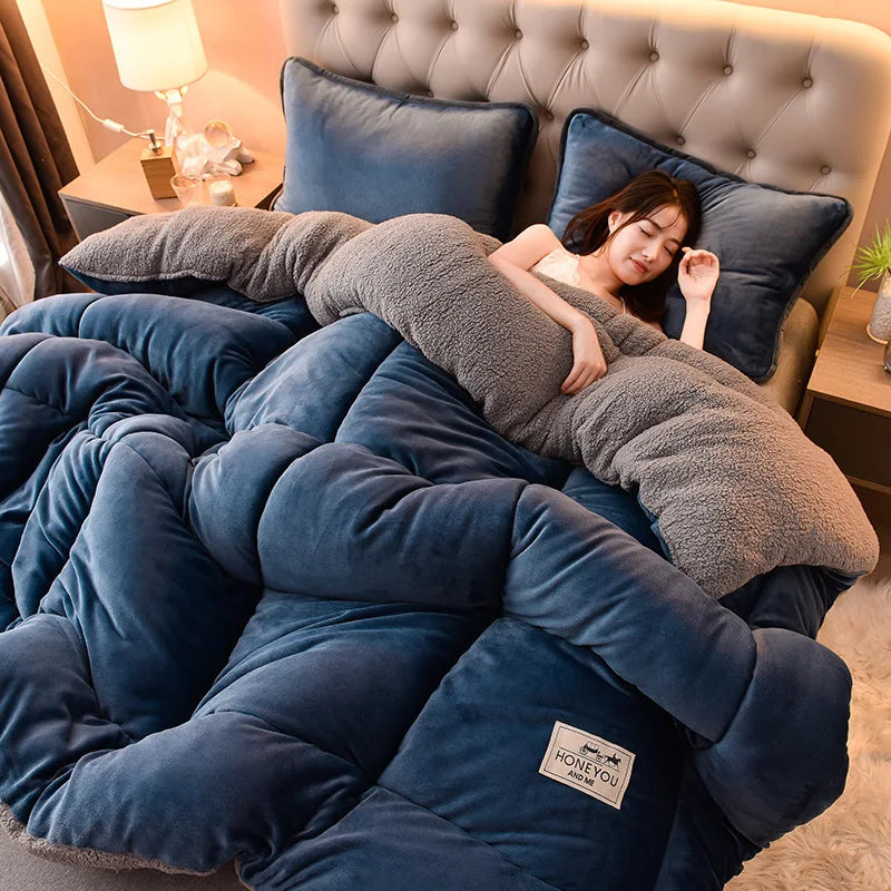 A woman is relaxing under a thick, blue velvet lamb wool blanket in a bedroom setting.