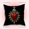 A black throw pillow cover featuring a silver heart sigil with a cross design.