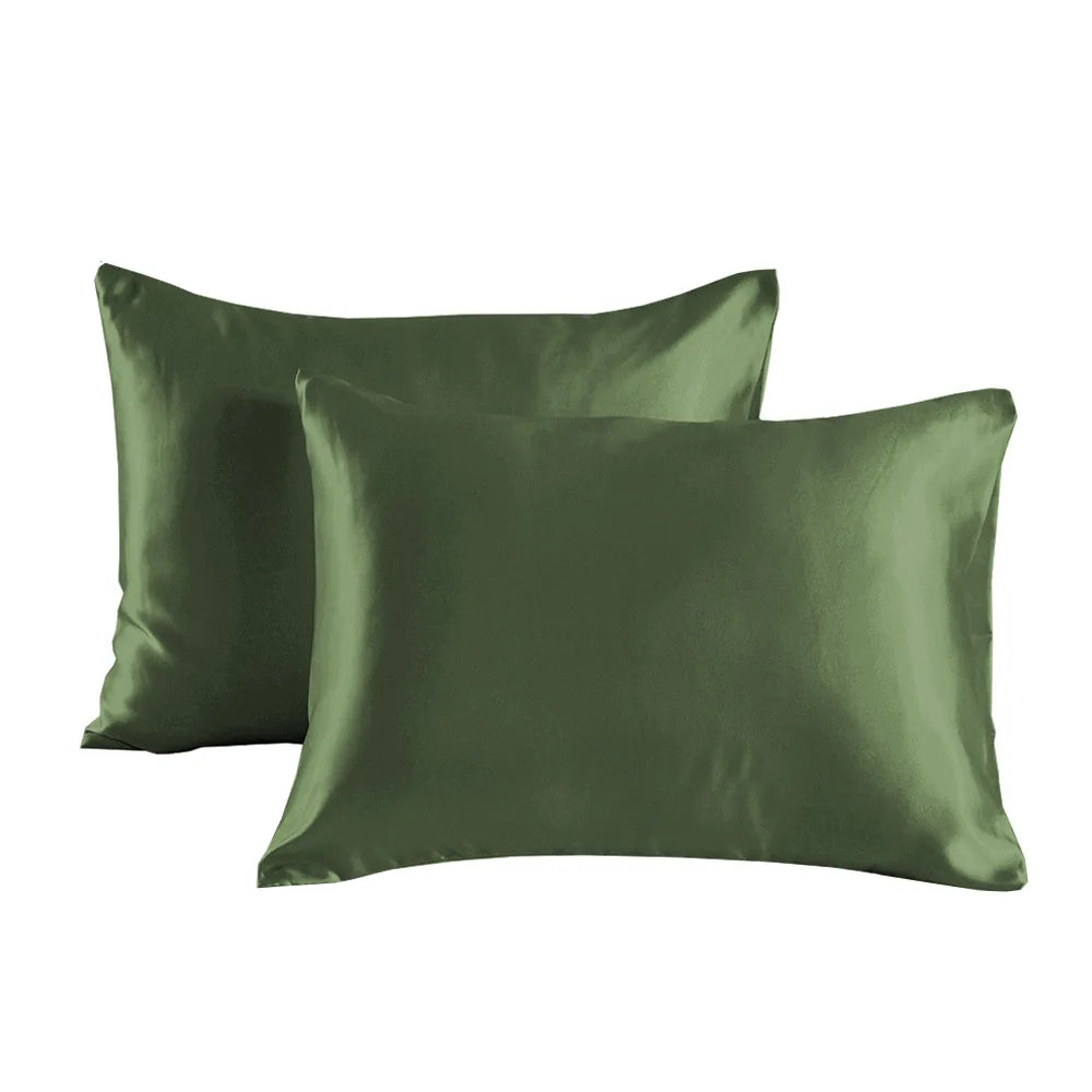A pair of olive green satin pillowcases lying flat.