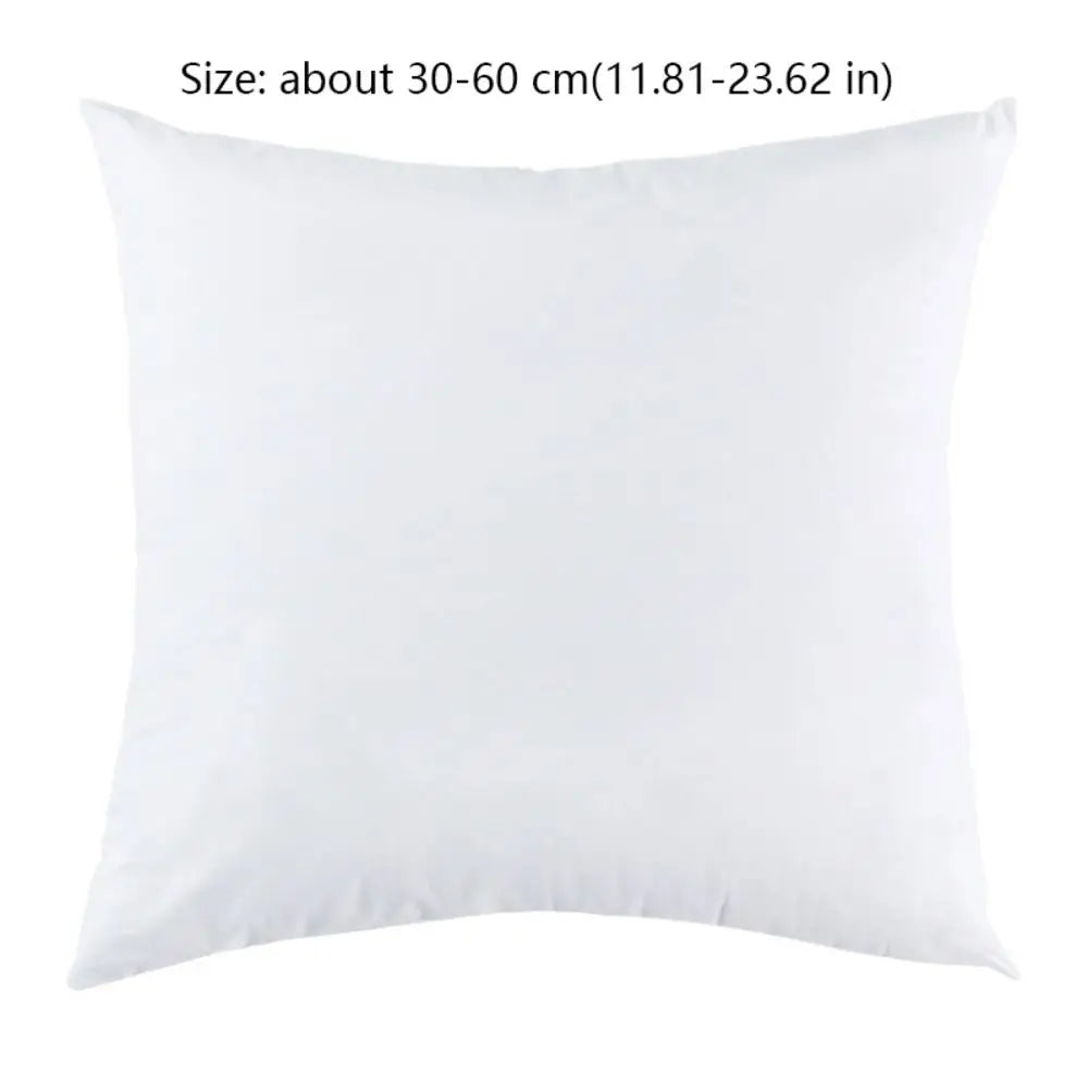 A square white cotton-filled decorative throw pillow insert.