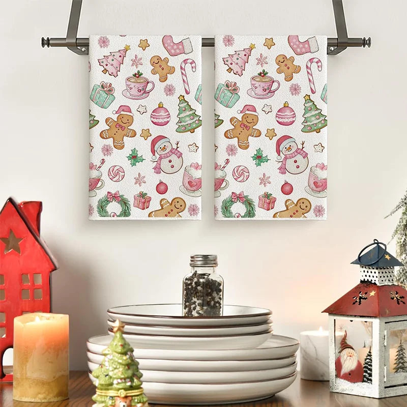 A set of two festive pink snowman Christmas kitchen towels featuring various holiday-themed designs.