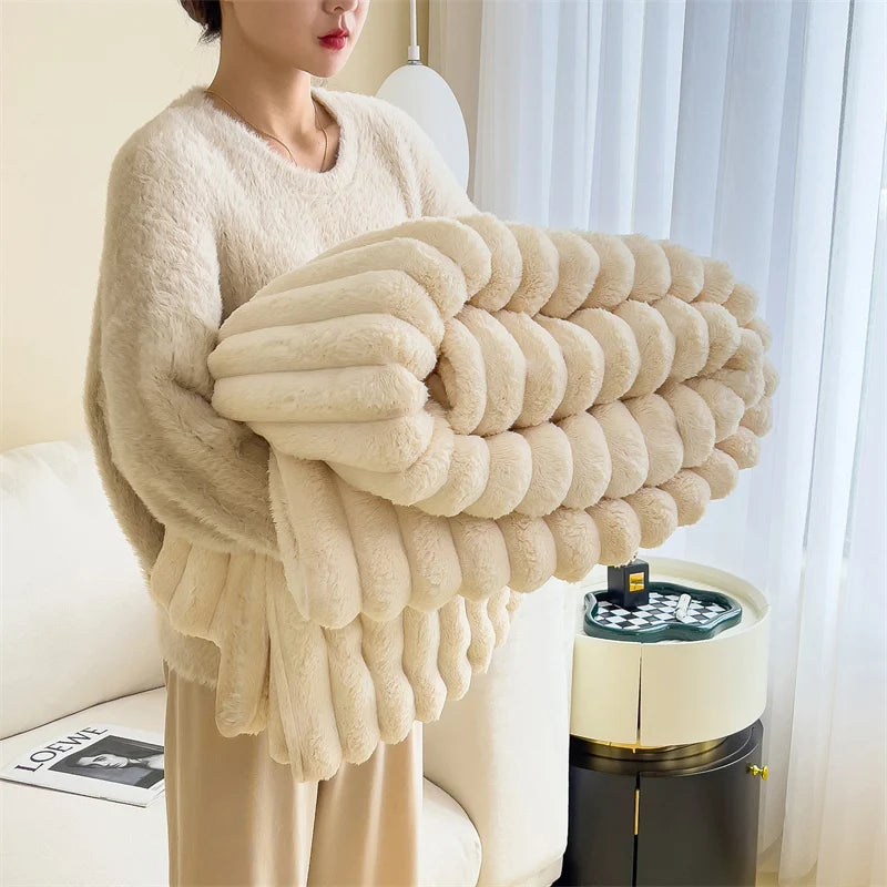 A beige ultra-soft plush winter blanket is draped over a person, showcasing its fluffy texture.