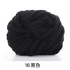 A ball of black chunky acrylic yarn for knitting and crochet projects.