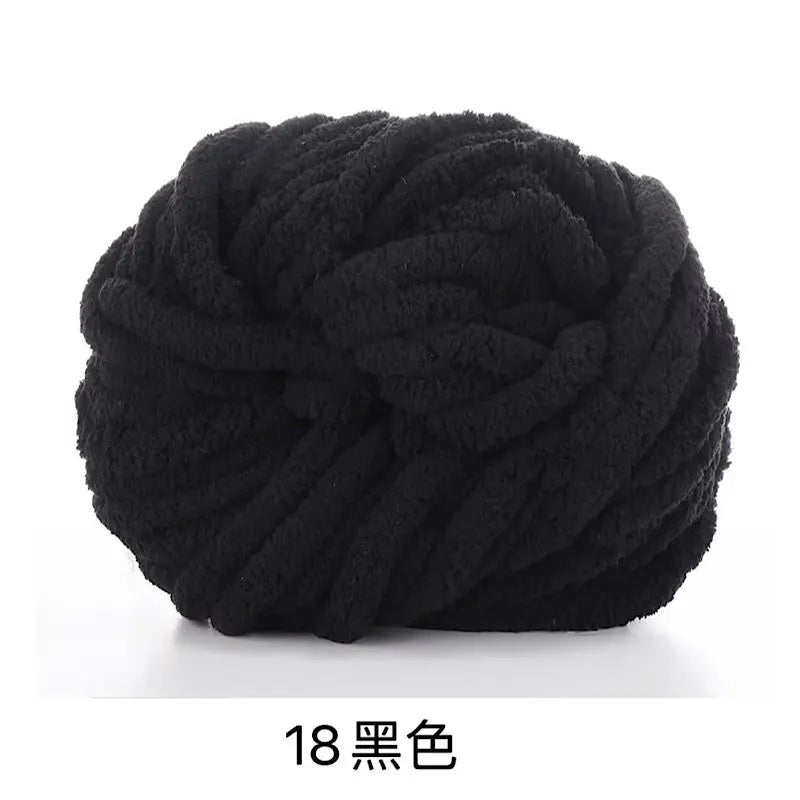 A ball of black chunky acrylic yarn for knitting and crochet projects.