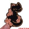 Black embroidered cat patch with light pink floral accents