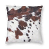A square cushion cover featuring a brown and white cowhide print faux fur design.