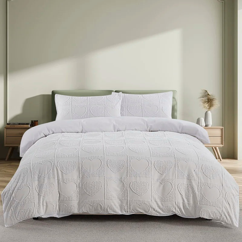White boho tufted microfiber duvet cover set displayed on a bed in a light-colored room.