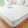 A white bamboo fiber fitted sheet is shown on a bed, with water dripping onto the surface.