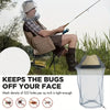 A person is using an extra large mosquito net with a face mask to keep bugs off their face.
