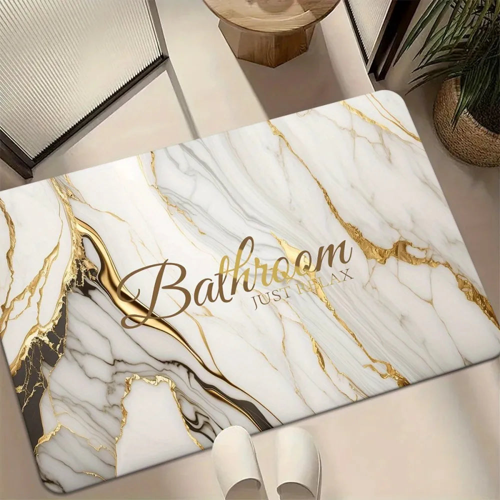 A rectangular door mat featuring a white marble pattern with gold veining and the text Bathroom Just In Lux