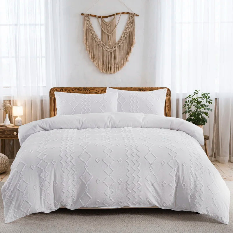 White tufted microfiber duvet cover set displayed on a bed with natural fiber macrame wall decor.